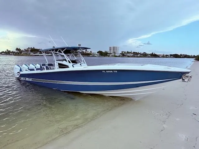  Yacht Photos Pics 2022 Nor-Tech 390 Sport Center Console boat on sandy shore, calm waters, and cloudy sky.