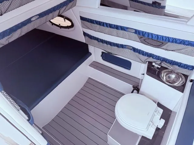  Yacht Photos Pics 2022 Nor-Tech 390 Sport Center Console cabin with bed, toilet, and sink.