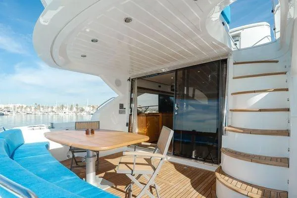 Zenyatta Yacht Photos Pics Sunseeker Manhattan 60 yacht deck with seating, table, and stairs, 2010 model.