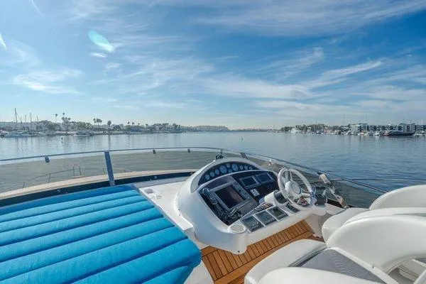 Zenyatta Yacht Photos Pics Flybridge view of 2010 Sunseeker Manhattan 60 yacht with serene waterfront backdrop.
