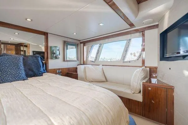 Zenyatta Yacht Photos Pics Luxurious Sunseeker Manhattan 60 yacht bedroom interior, 2010 model, featuring elegant wood finishes.