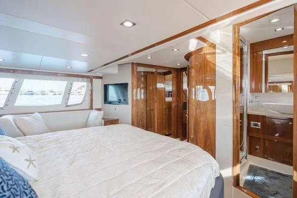 Zenyatta Yacht Photos Pics Luxurious Sunseeker Manhattan 60 yacht bedroom interior, 2010 model, featuring elegant wood finishes.