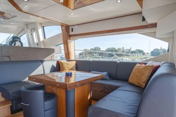 Zenyatta Yacht Photos Pics Luxurious interior of 2010 Sunseeker Manhattan 60 yacht with elegant seating and table.