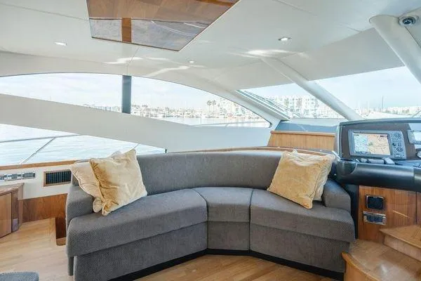 Zenyatta Yacht Photos Pics Luxurious Sunseeker Manhattan 60 yacht interior with plush seating, panoramic windows, and navigation equipment.