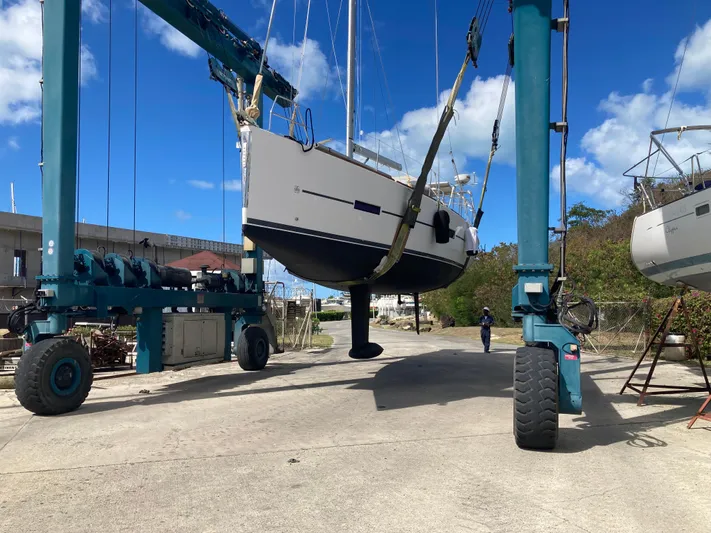 Caff&Eacute; Latte Yacht Photos Pics Dufour 410 Grand Large 2013 sailboat being lifted by crane at a marina.