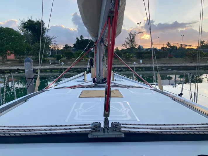 Caff&Eacute; Latte Yacht Photos Pics Dufour 410 Grand Large 2013 sailboat deck at sunset, docked in a serene marina.