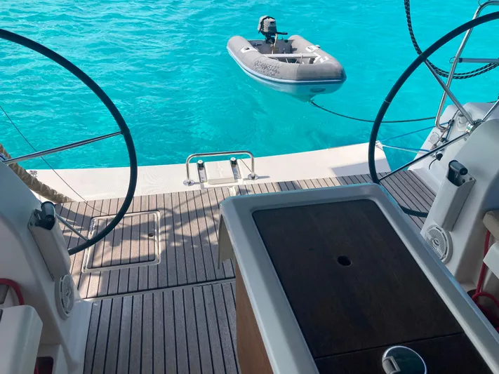 Caff&Eacute; Latte Yacht Photos Pics Dufour 410 Grand Large 2013 yacht deck with inflatable dinghy on turquoise water.