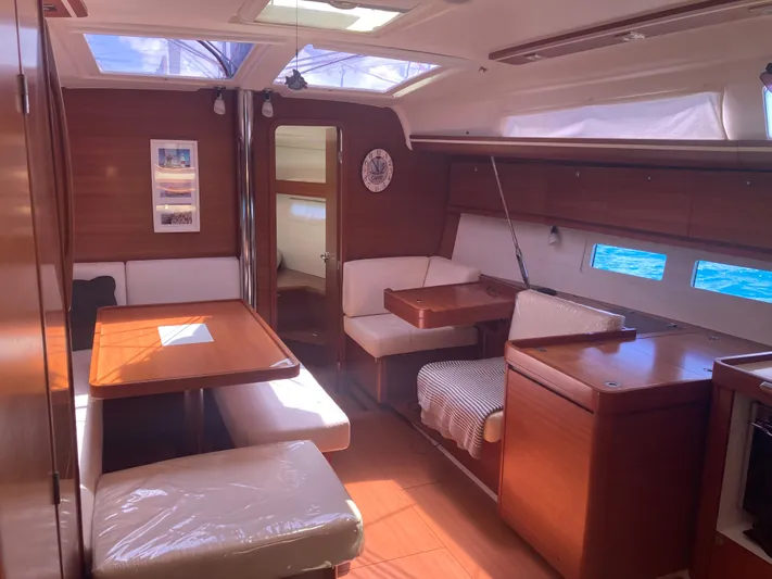 Caff&Eacute; Latte Yacht Photos Pics Interior of 2013 Dufour 410 Grand Large yacht with wooden furnishings and seating area.