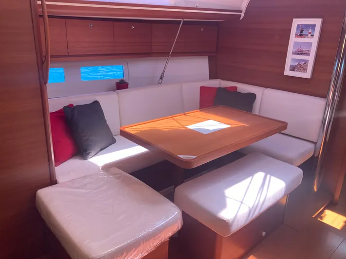 Caff&Eacute; Latte Yacht Photos Pics Interior of 2013 Dufour 410 Grand Large yacht with cozy seating and wooden table.