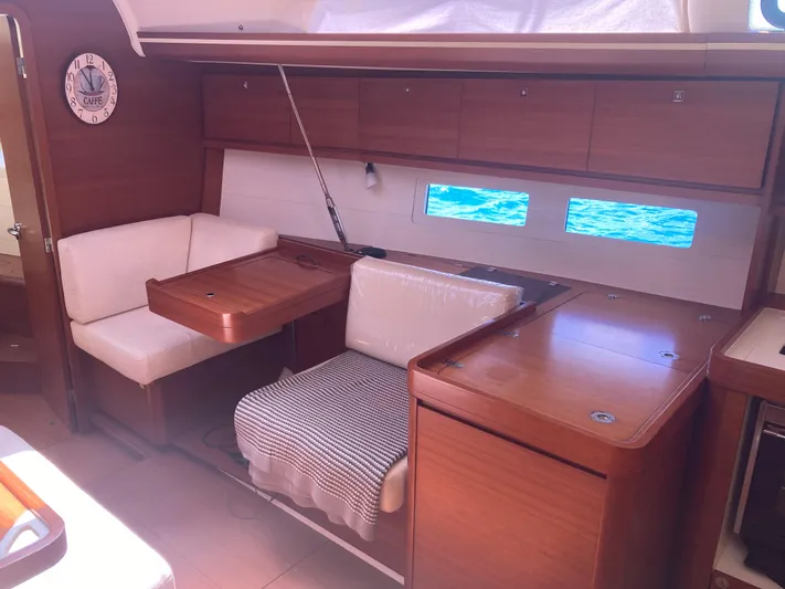 Caff&Eacute; Latte Yacht Photos Pics Interior of 2013 Dufour 410 Grand Large yacht with wooden furnishings and seating area.