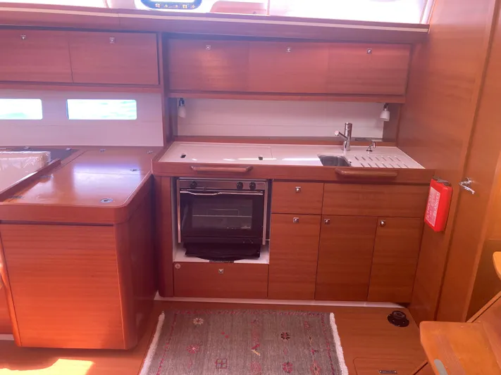 Caff&Eacute; Latte Yacht Photos Pics 2013 Dufour 410 Grand Large yacht kitchen with wooden cabinets, oven, and sink.