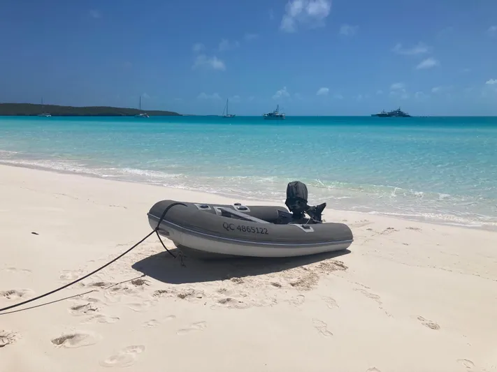 Caff&Eacute; Latte Yacht Photos Pics Inflatable boat on sandy beach with turquoise water, Dufour 410 Grand Large in background.