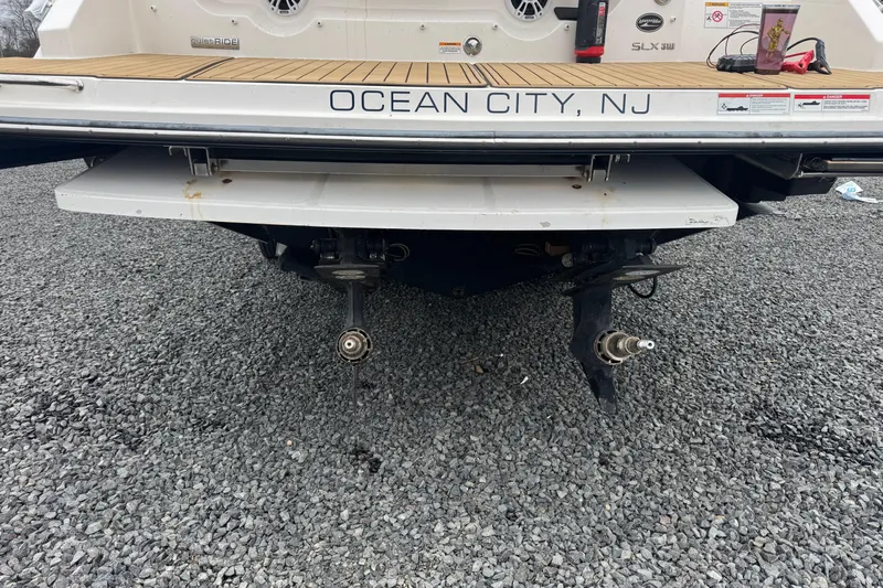  Yacht Photos Pics 2021 Sea Ray SLX 310 boat rear view, Ocean City, NJ, on gravel surface.
