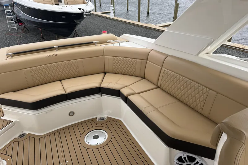  Yacht Photos Pics Luxurious seating on 2021 Sea Ray SLX 310 boat with tan upholstery and teak flooring.