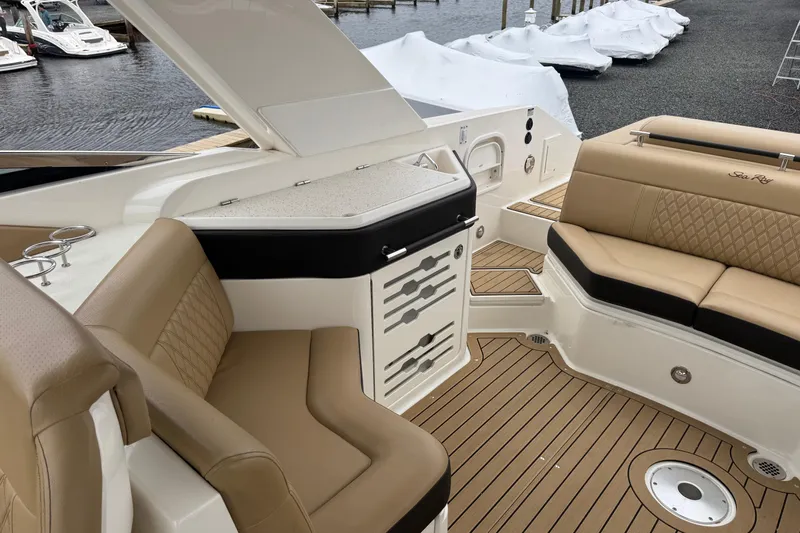  Yacht Photos Pics 2021 Sea Ray SLX 310 boat interior with tan seating and wood-style flooring.