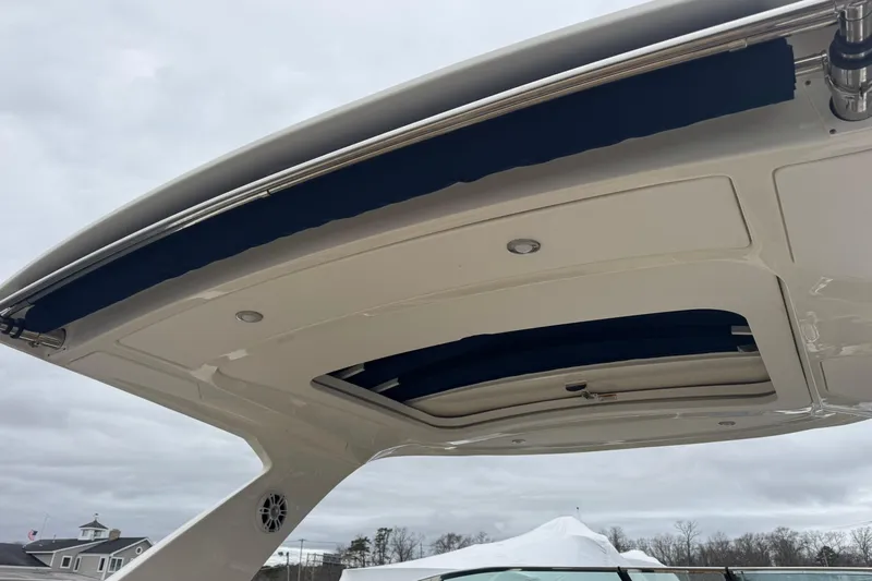  Yacht Photos Pics 2021 Sea Ray SLX 310 boat canopy and roof detail under cloudy sky.