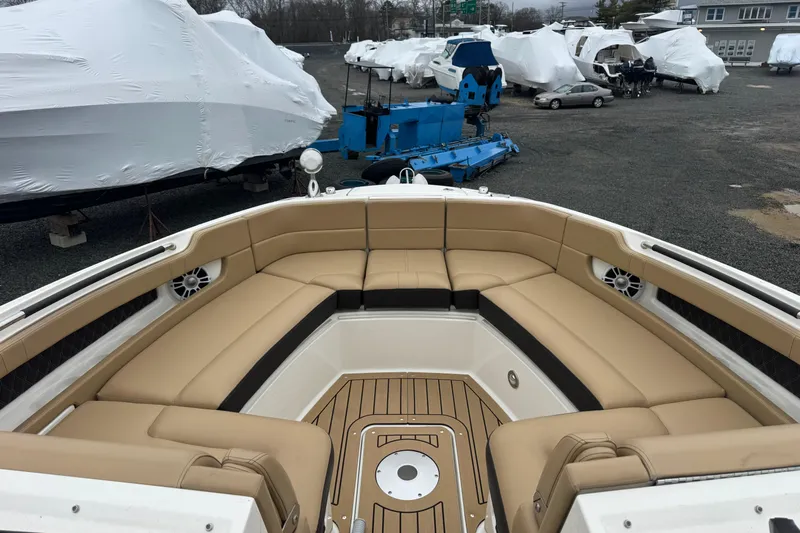  Yacht Photos Pics 2021 Sea Ray SLX 310 boat with tan seating, docked among covered boats.