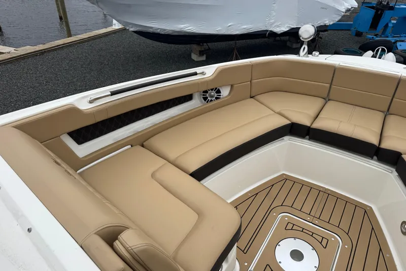  Yacht Photos Pics 2021 Sea Ray SLX 310 boat interior with tan seating and wood-style flooring.