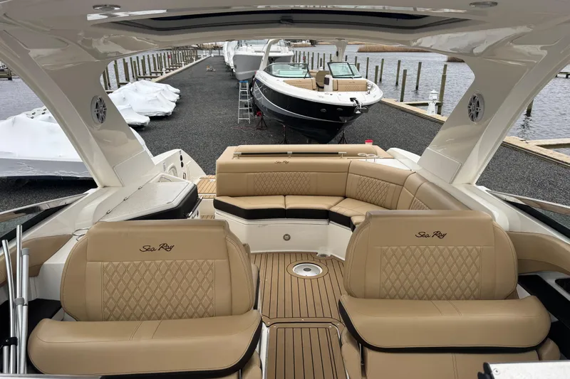  Yacht Photos Pics 2021 Sea Ray SLX 310 boat with luxurious tan seating and spacious deck at a marina.