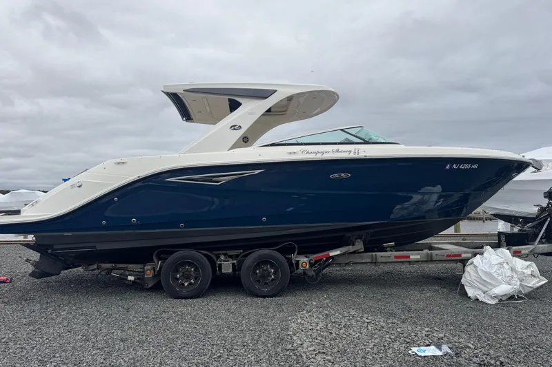  Yacht Photos Pics 2021 Sea Ray SLX 310 boat on trailer, blue and white design, overcast sky.