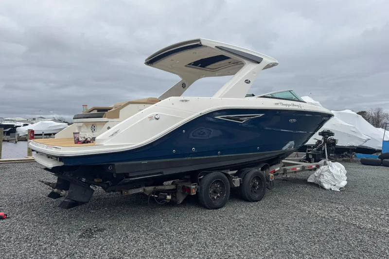  Yacht Photos Pics 2021 Sea Ray SLX 310 boat on trailer, parked outdoors under cloudy sky.