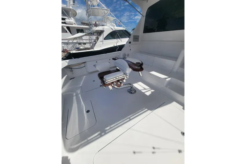  Yacht Photos Pics Spacious deck of 2012 Viking 64c yacht with fishing chair and clear sky.