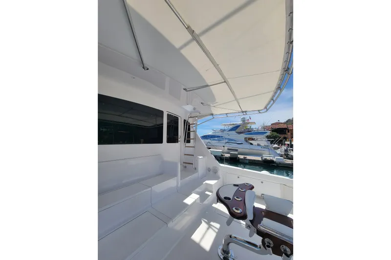  Yacht Photos Pics 2012 Viking 64c yacht deck with seating and fishing chair, docked at marina.