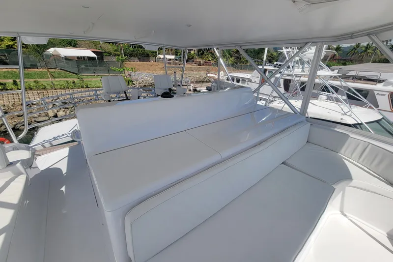  Yacht Photos Pics Spacious seating area on a 2012 Viking 64c yacht, docked with scenic background.