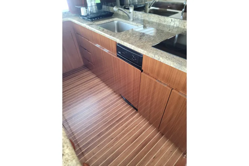  Yacht Photos Pics Luxurious kitchen interior of 2012 Viking 64c yacht with wooden cabinetry and granite countertops.