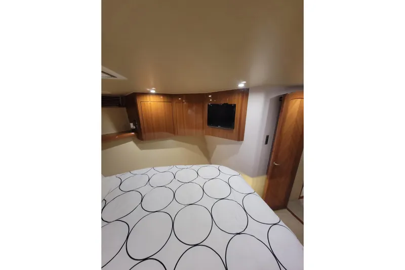  Yacht Photos Pics Interior of 2012 Viking 64c yacht with modern wood paneling and cozy bedding.