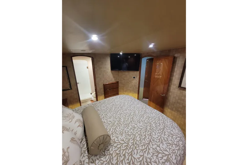  Yacht Photos Pics Luxurious bedroom interior of 2012 Viking 64c yacht with elegant decor and modern amenities.