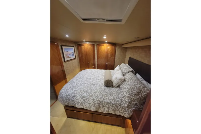  Yacht Photos Pics Luxurious bedroom interior of 2012 Viking 64c yacht with elegant bedding and wood finishes.