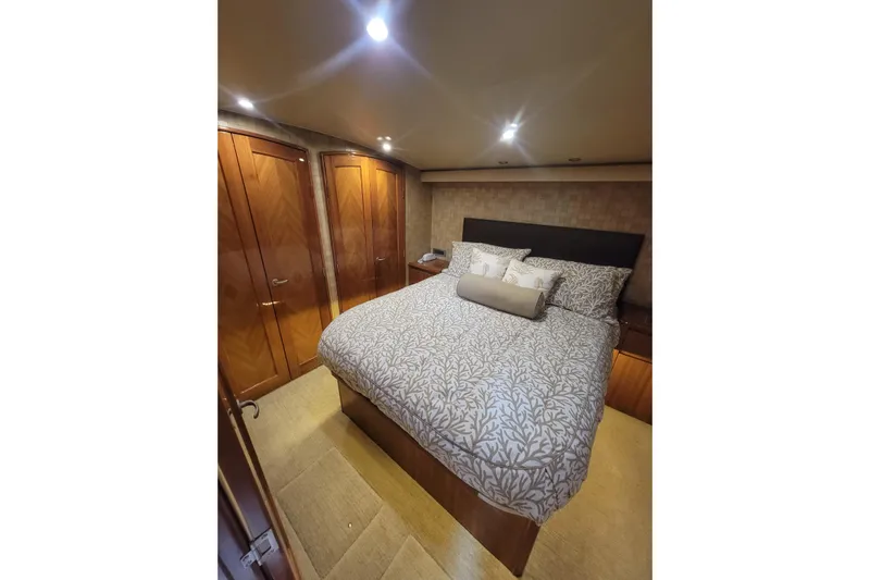  Yacht Photos Pics Luxurious bedroom interior of 2012 Viking 64c yacht with elegant bedding and wooden cabinetry.