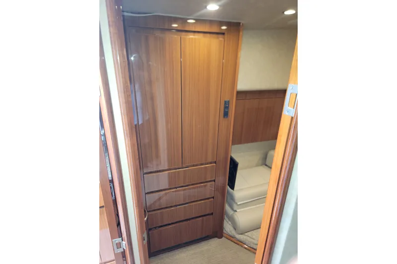  Yacht Photos Pics Interior of 2012 Viking 64c yacht with wooden cabinetry and seating area.
