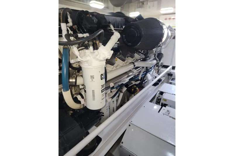  Yacht Photos Pics Engine compartment of a 2012 Viking 64c yacht, showcasing detailed components and filters.