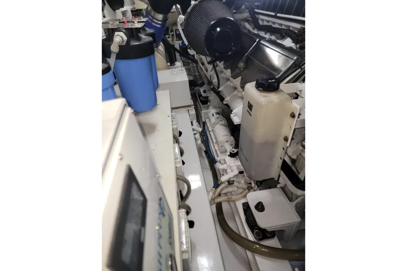  Yacht Photos Pics Engine room of a 2012 Viking 64c yacht, showcasing mechanical components and fluid containers.