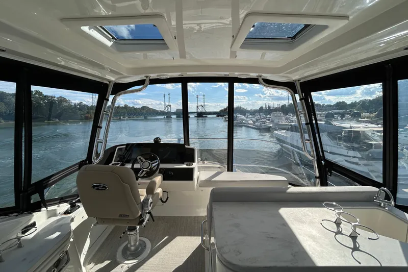  Yacht Photos Pics Interior view of 2018 Sea Ray Fly 520 yacht with scenic marina backdrop.