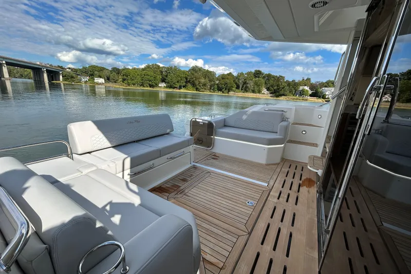  Yacht Photos Pics Luxurious 2018 Sea Ray Fly 520 yacht deck with elegant seating and scenic water view.