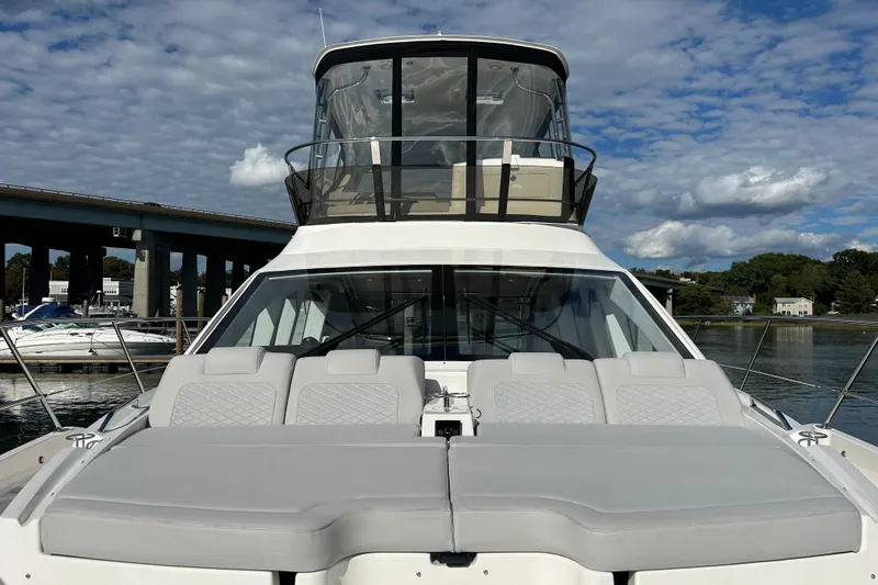  Yacht Photos Pics 2018 Sea Ray Fly 520 yacht with spacious deck and flybridge, docked under a blue sky.