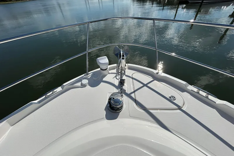  Yacht Photos Pics Bow view of 2018 Sea Ray Fly 520 yacht on calm water.