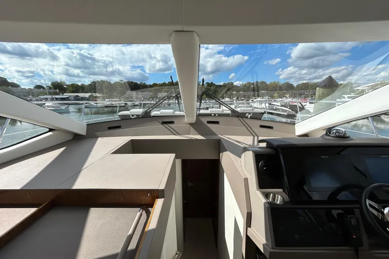  Yacht Photos Pics Interior view of 2018 Sea Ray Fly 520 yacht with panoramic windows and modern dashboard.
