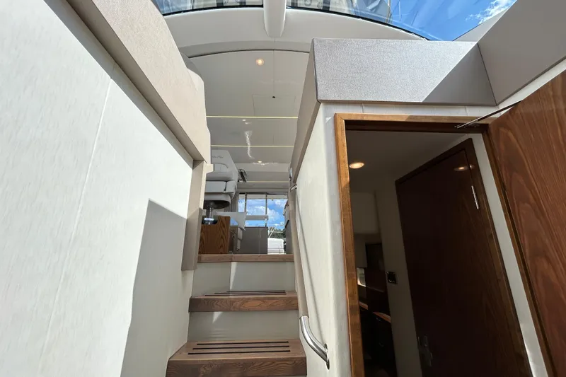  Yacht Photos Pics Interior view of 2018 Sea Ray Fly 520 yacht, featuring wooden stairs and modern design.