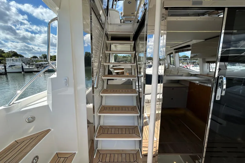  Yacht Photos Pics Staircase on 2018 Sea Ray Fly 520 yacht, leading to upper deck with marina view.