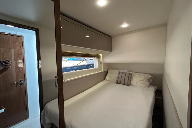  Yacht Photos Pics Luxurious cabin interior of 2018 Sea Ray Fly 520 yacht with cozy bed and window.