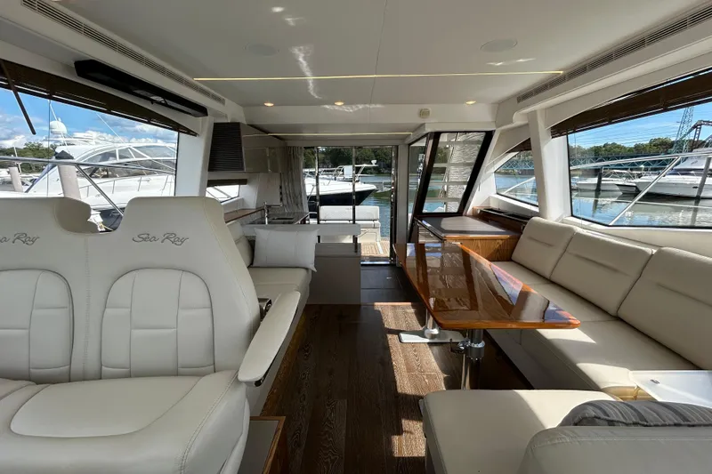  Yacht Photos Pics Luxurious interior of 2018 Sea Ray Fly 520 yacht with elegant seating and wooden table.