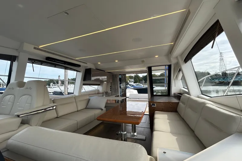 Yacht Photos Pics Luxurious interior of 2018 Sea Ray Fly 520 yacht with elegant seating and panoramic windows.
