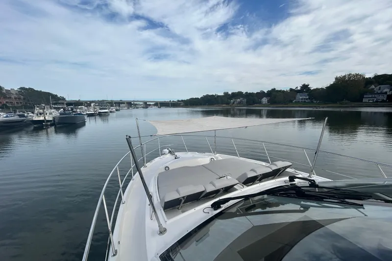  Yacht Photos Pics 2018 Sea Ray Fly 520 yacht on calm waters with scenic marina view.