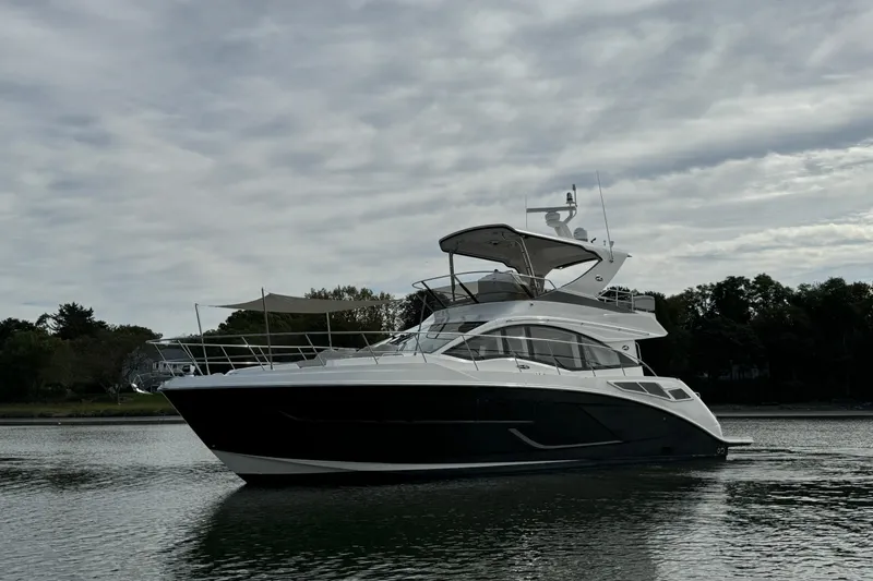  Yacht Photos Pics 2018 Sea Ray Fly 520 yacht on calm water under cloudy sky.