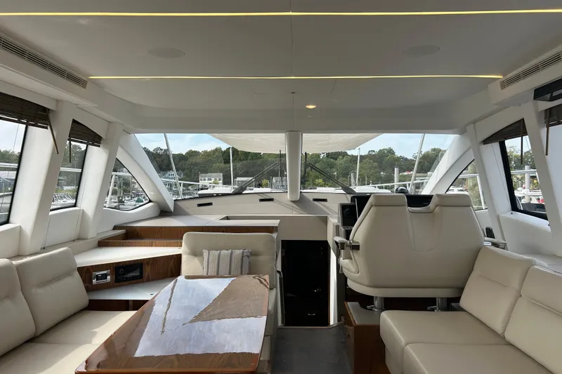  Yacht Photos Pics Luxurious interior of 2018 Sea Ray Fly 520 yacht with modern seating and panoramic windows.