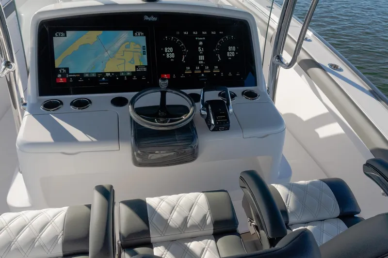  Yacht Photos Pics 2026 Mag Bay 43 CC boat dashboard with navigation screens and steering wheel.